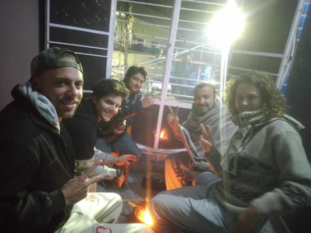 a group of people sitting around a table at night at Hostel Relax Homestay in Gaya