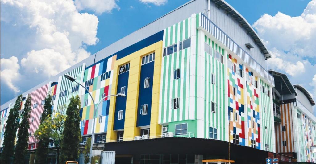 a building with many colors on the side of it at D'Carol Hotel in Surabaya