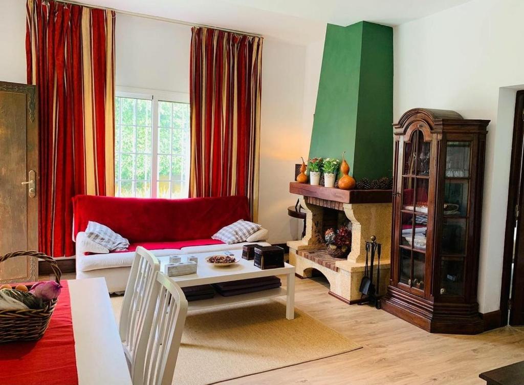 a living room with a red couch and a fireplace at La Chimenea Verde in Tacoronte