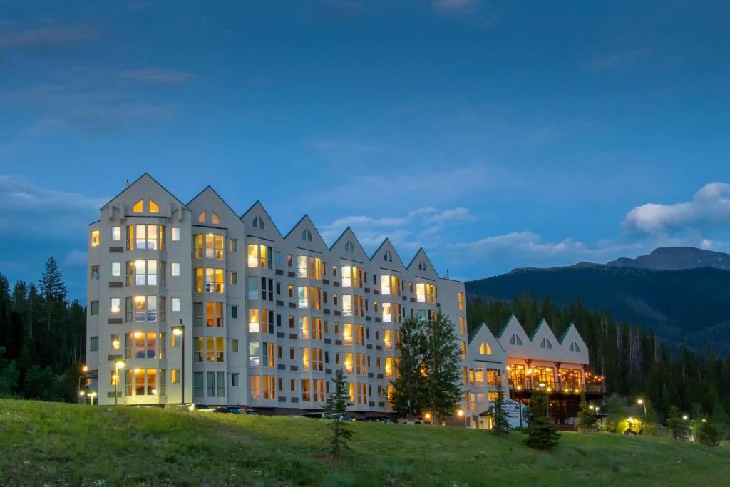 a hotel on top of a hill at night at Winter Park Mountain Lodge in Winter Park