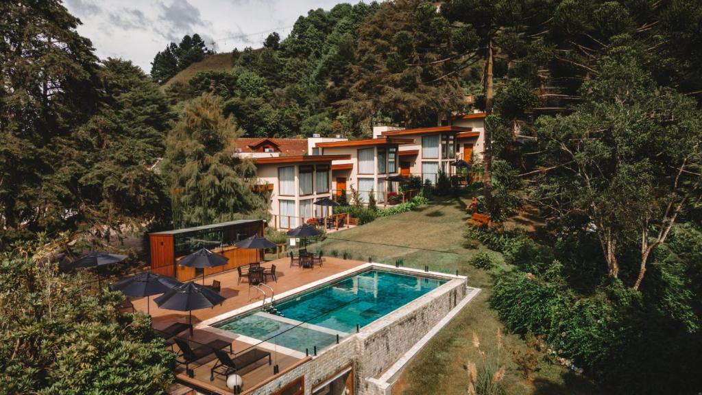 an aerial view of a house with a swimming pool at Hotel Boutique QUEBRA-NOZ in Campos do Jordão