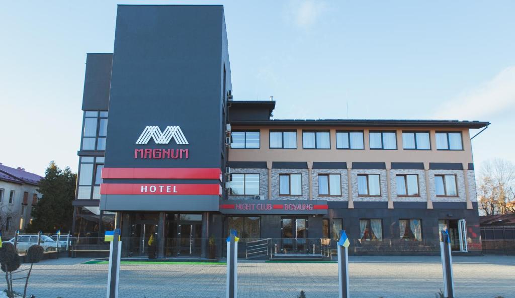 a hotel with a sign on the front of it at Magnum in Berehove