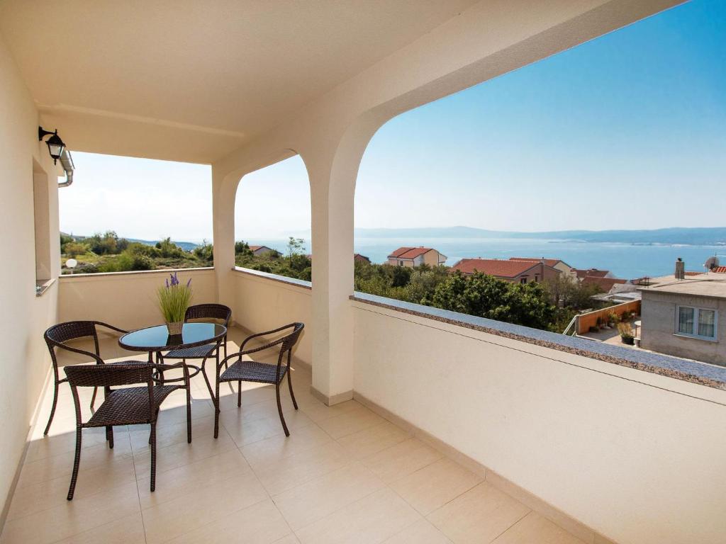 balcone con tavolo, sedie e vista sull'oceano di Apartment Nikol - CKV122 by Interhome a Crikvenica