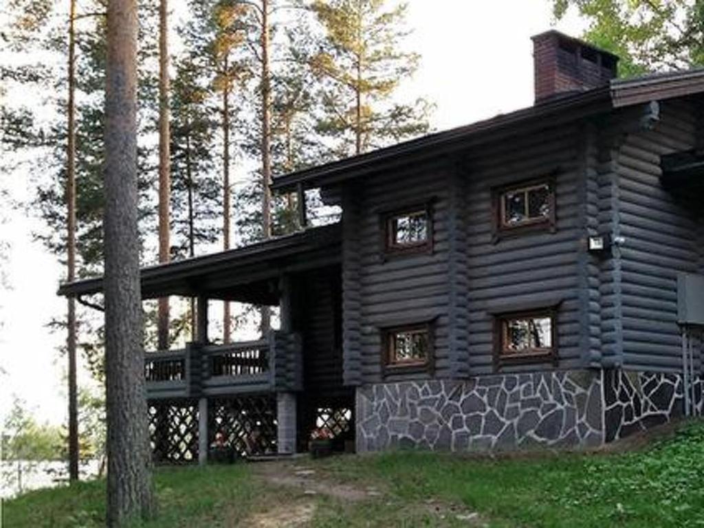 a log cabin with graffiti on the side of it at Holiday Home Rihka by Interhome in Luopioinen