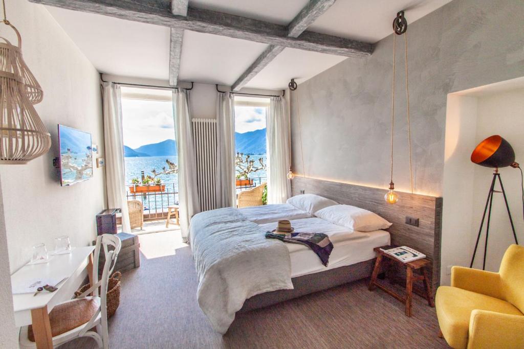 a bedroom with a bed with a view of the ocean at Seven Boutique Hotel in Ascona