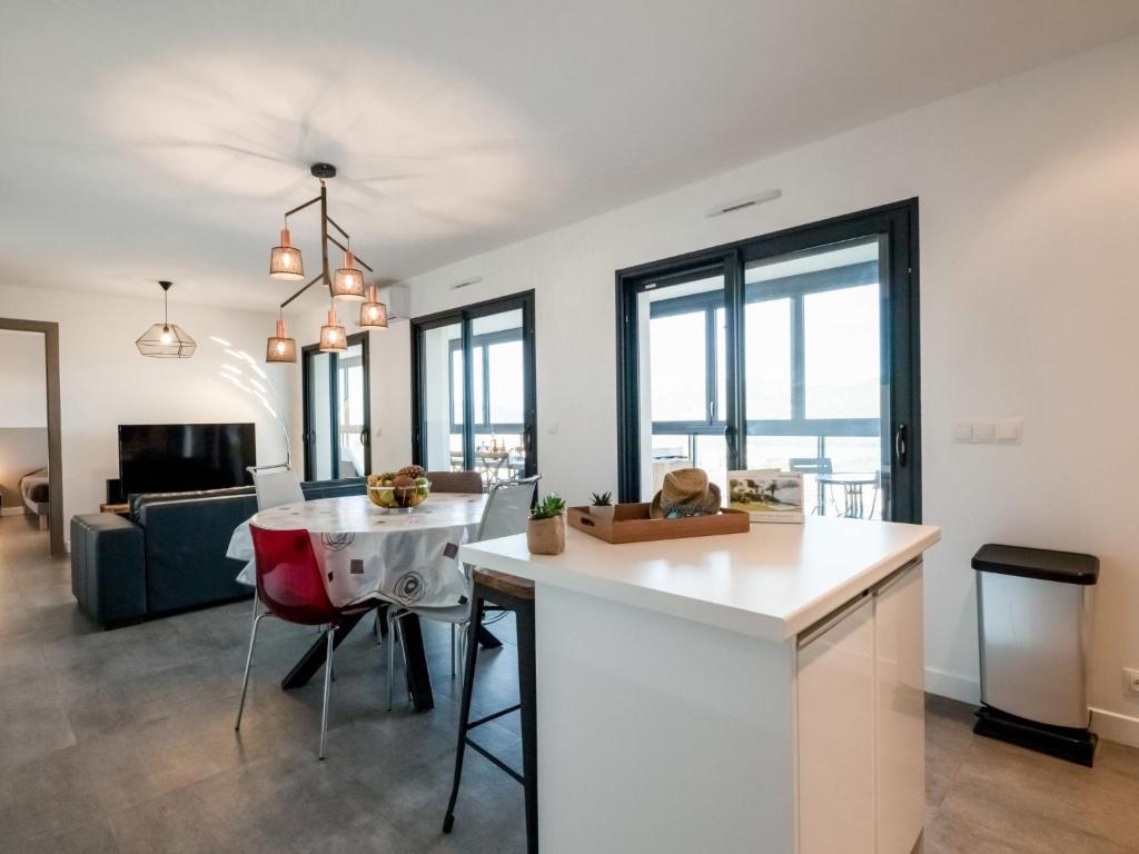 a kitchen and living room with a table and chairs at Apartment Château-5 by Interhome in Porto-Vecchio