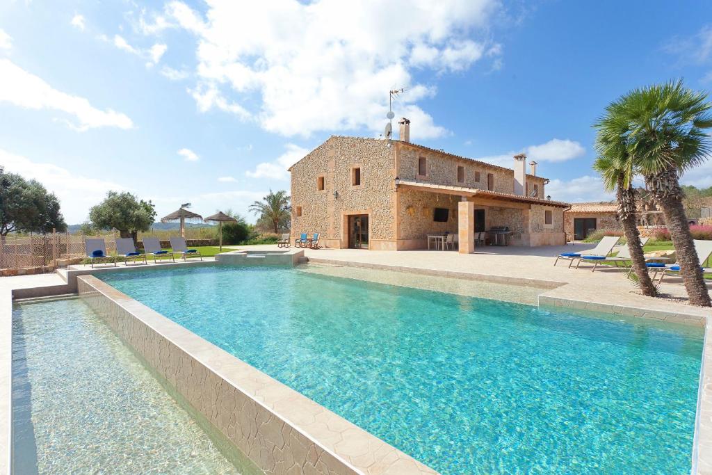 a large swimming pool in front of a house at Sa Murtera in Manacor