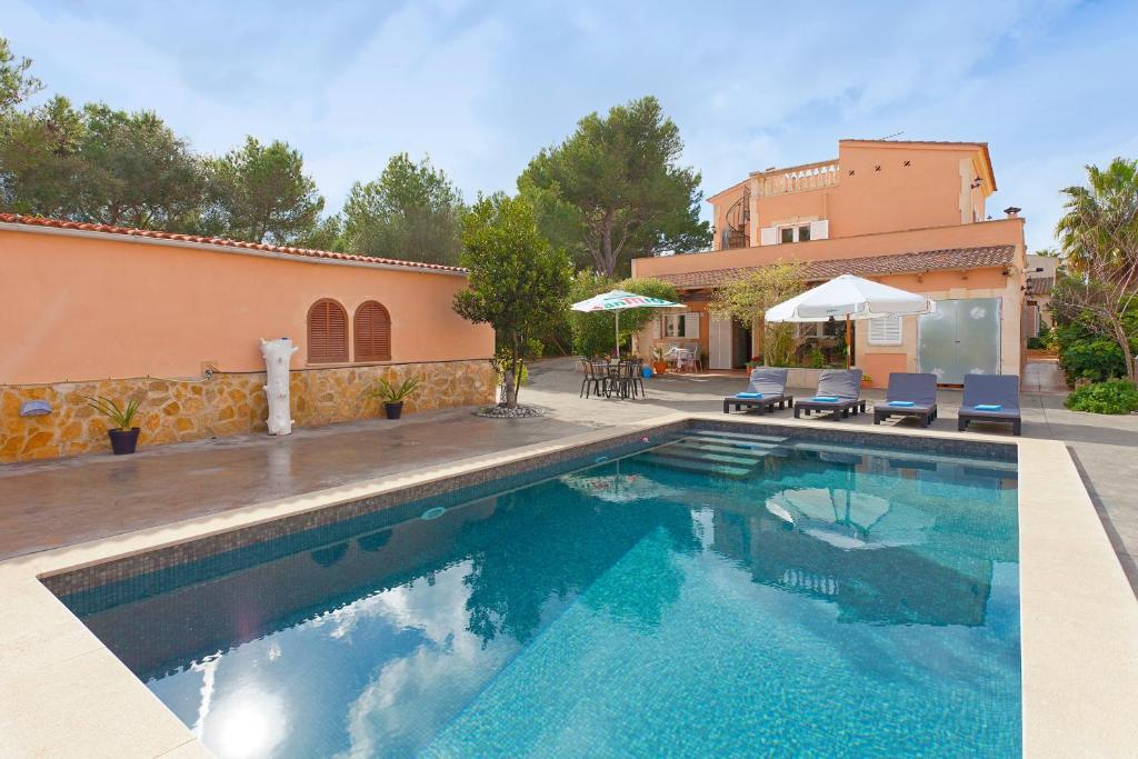 a swimming pool in front of a house at Villa Angela in Urbanicacion ses palmeres