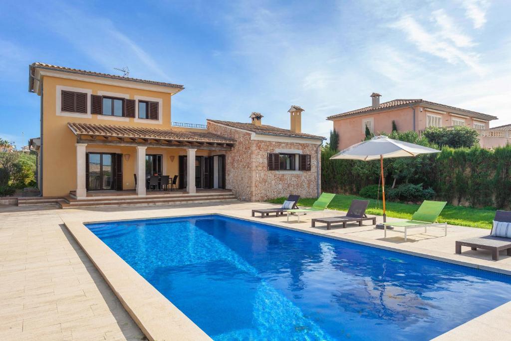 a villa with a swimming pool and a house at Villa Sa Torre in Sa Torre