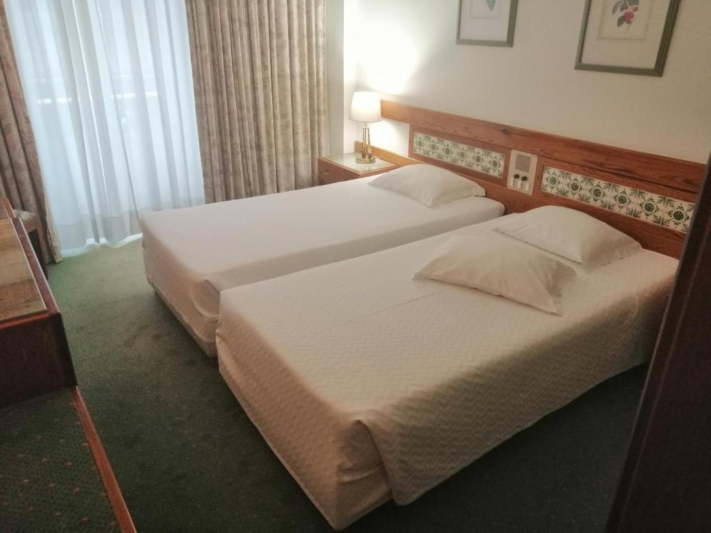 Postel nebo postele na pokoji v ubytování Hotel Universal