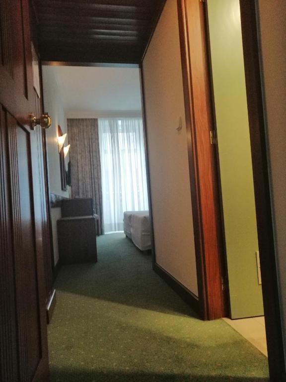 Postel nebo postele na pokoji v ubytování Hotel Universal