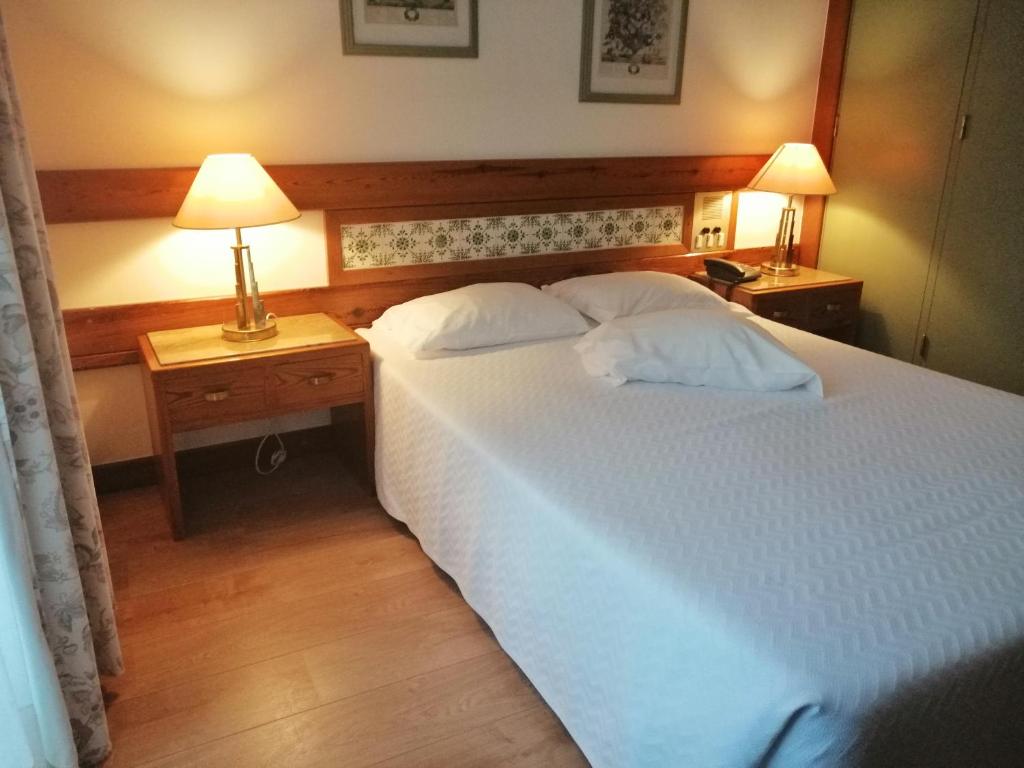 Postel nebo postele na pokoji v ubytování Hotel Universal