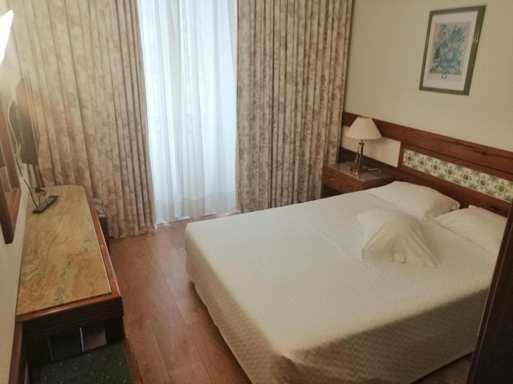 Postel nebo postele na pokoji v ubytování Hotel Universal