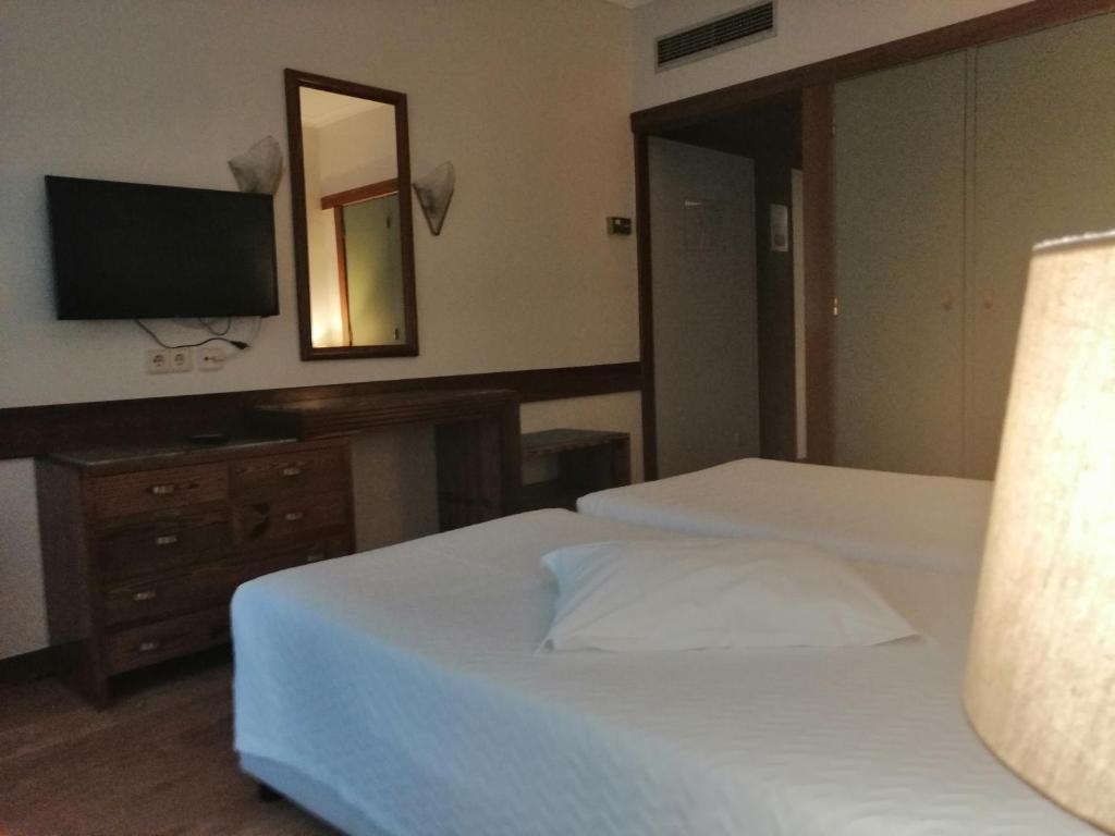 Postel nebo postele na pokoji v ubytování Hotel Universal