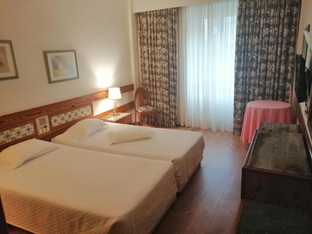 Postel nebo postele na pokoji v ubytování Hotel Universal