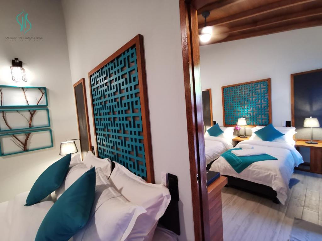 Postel nebo postele na pokoji v ubytování Village Hideaways & Spas