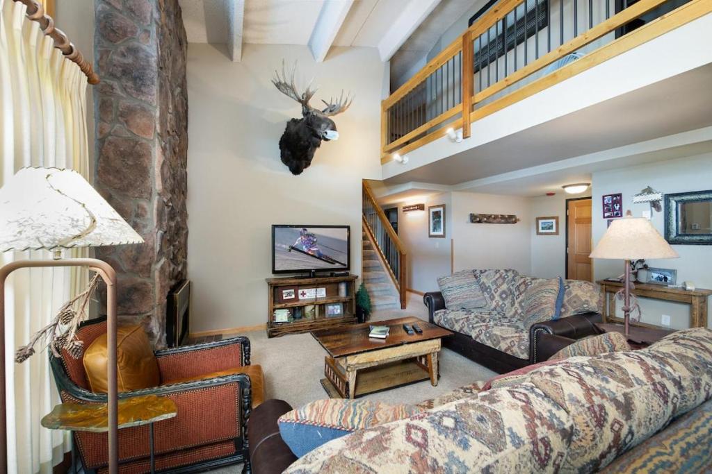 sala de estar con sofá y mesa en Trails End Penthouse - Ski In - Out - Stroll To Main Street en Breckenridge