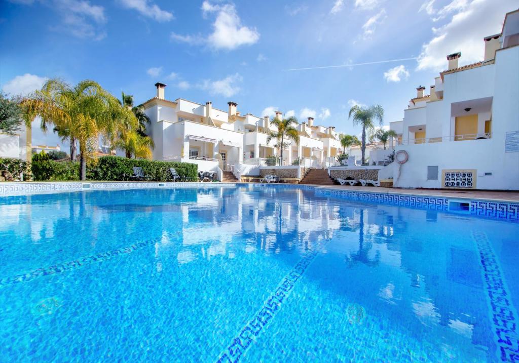 a large swimming pool in front of a villa at Villa Albufeira in Albufeira