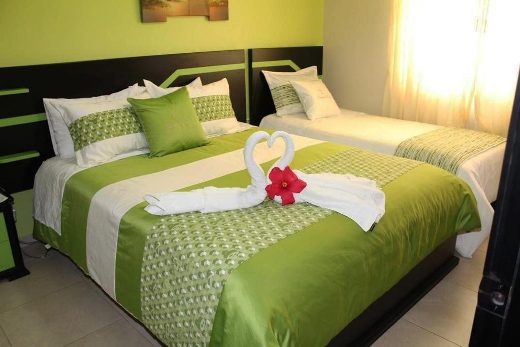 Postel nebo postele na pokoji v ubytování Hotel Tababela Land