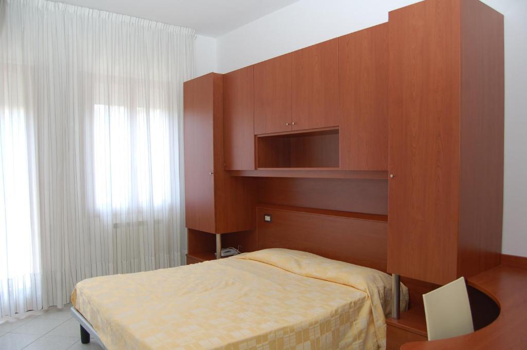 Postel nebo postele na pokoji v ubytování Albergo Arcobaleno
