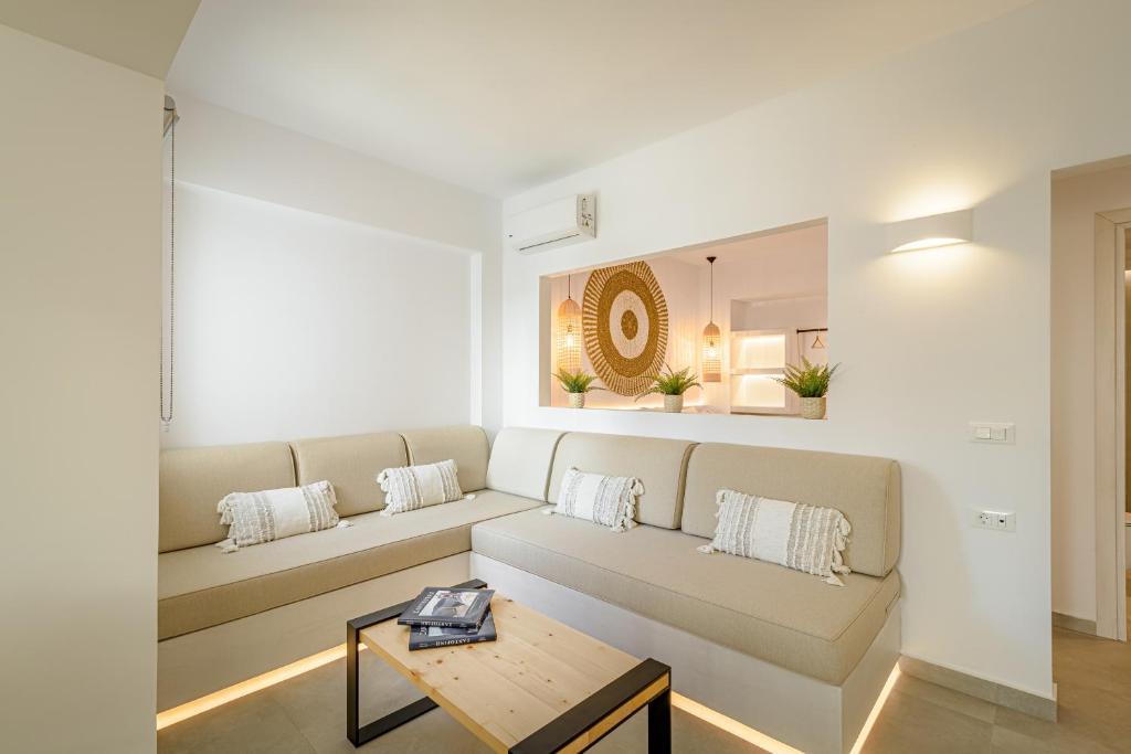 uma sala de estar com um sofá e uma mesa em Thealos Santorini em Pirgos