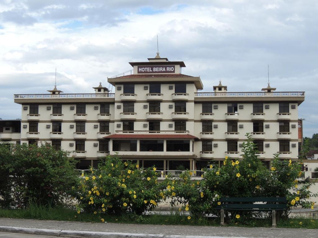 a large white building with a sign on top of it at Hotel Beira Rio in Brusque