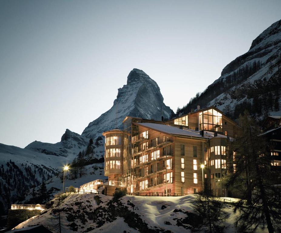 
a large building with a ski lift on top of it at The Omnia in Zermatt
