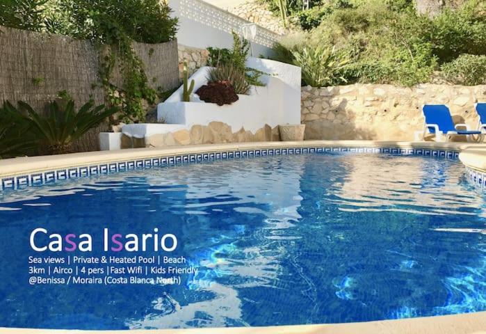 una piscina con sillas azules en un patio en Charming Villa in Montemar with private pool and sea views, en Benissa