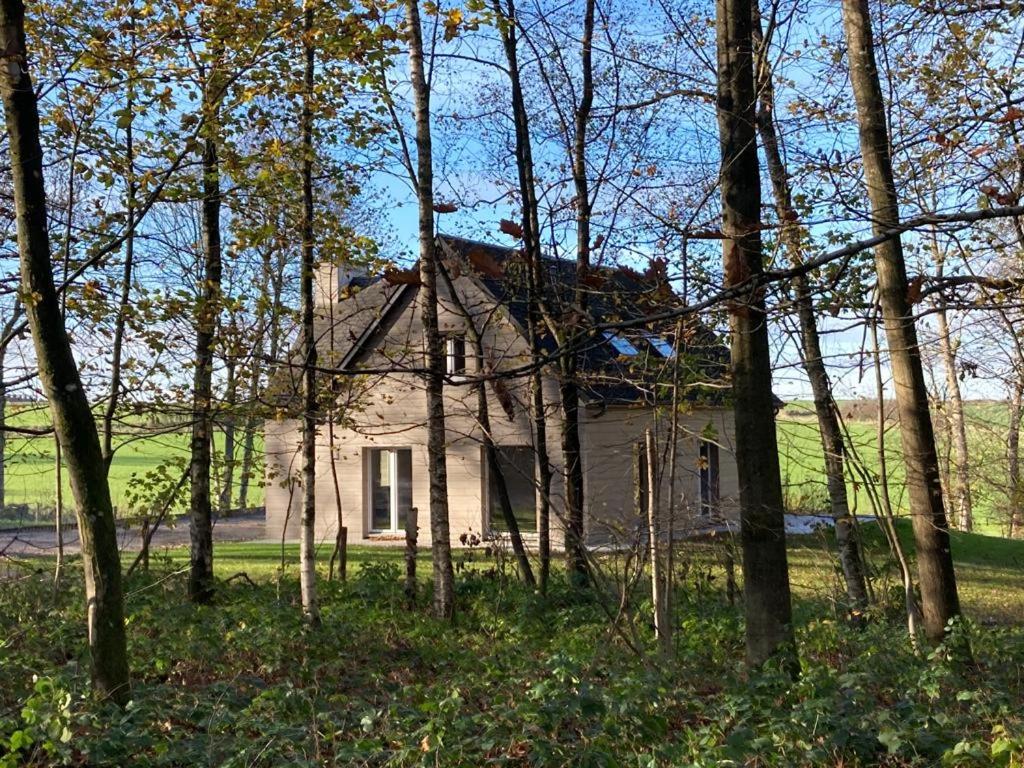 an old house in the middle of a forest of trees at Au Bois de Rosée in Florennes
