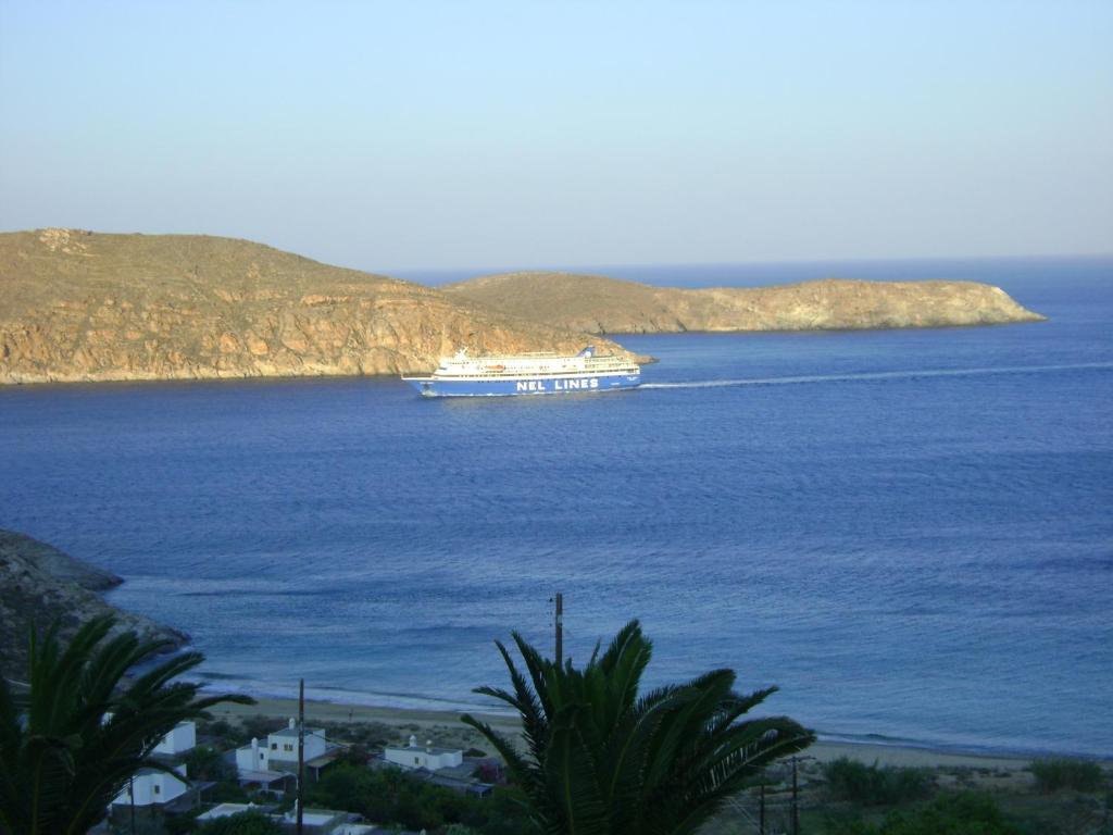 a large boat in the water with a island at Chez Semiramis The Sun Touch House for 8 persons 5'min from the beach in Rámos