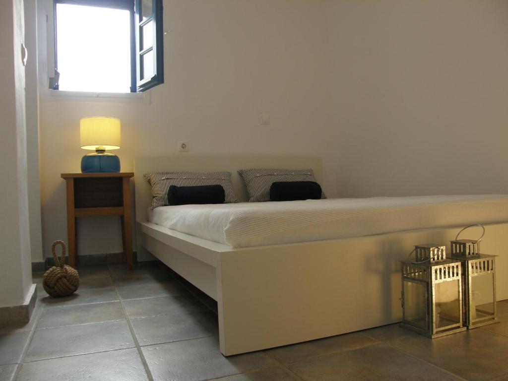 a bedroom with a large bed with a window at Chez Semiramis The Sun Touch House for 8 persons 5'min from the beach in Rámos