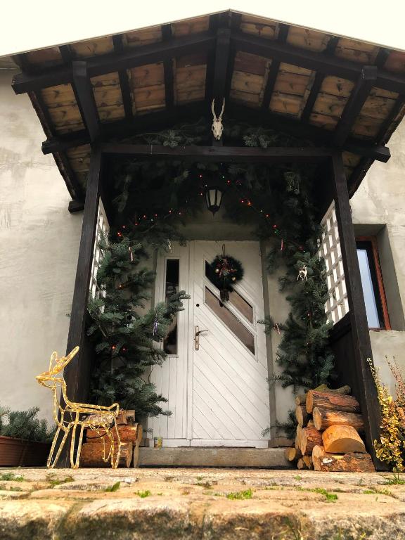 a white door with christmas wreaths on it at Leśna Willa in Kowalewo