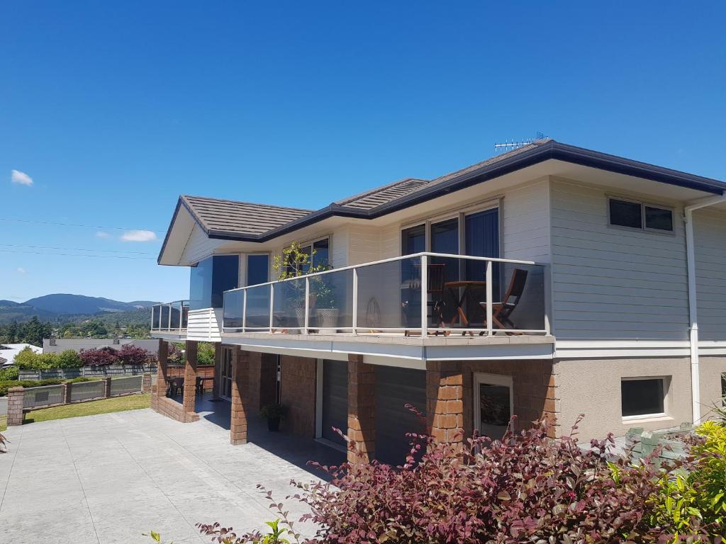 a large house with a balcony on top of it at Rotorua Views B&B/Apartment in Rotorua