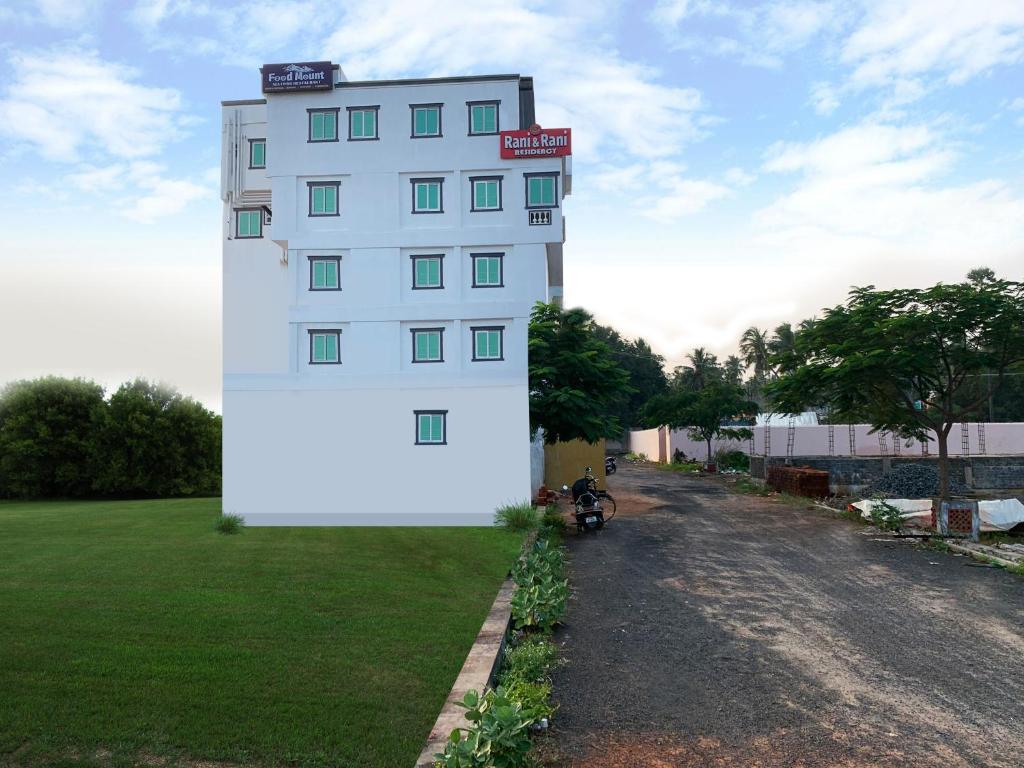 a white building with a sign on the side of it at Hotel Rani and Rani Residency in Puducherry