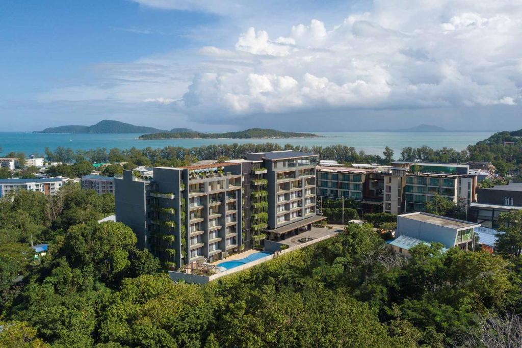 an aerial view of a city with buildings and the water at Calypso Garden by Villacarte in Rawai Beach