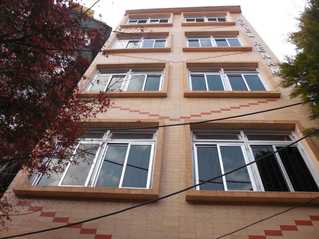 a tall building with windows on the side of it at Hotel Renam in Gangtok