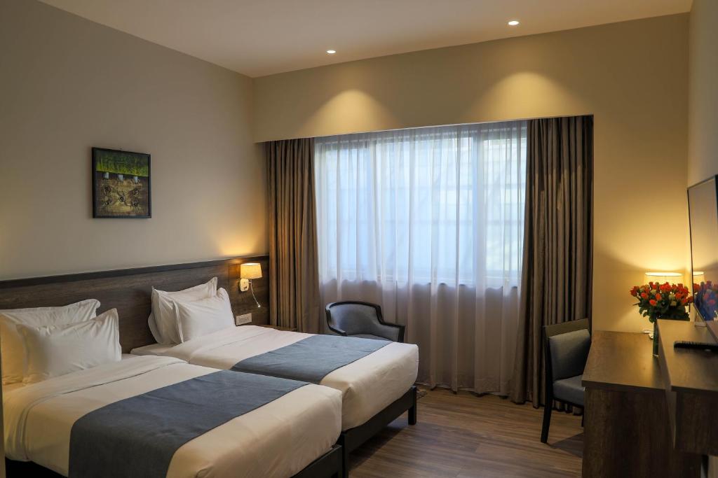 Postel nebo postele na pokoji v ubytování Eka Hotel Eldoret