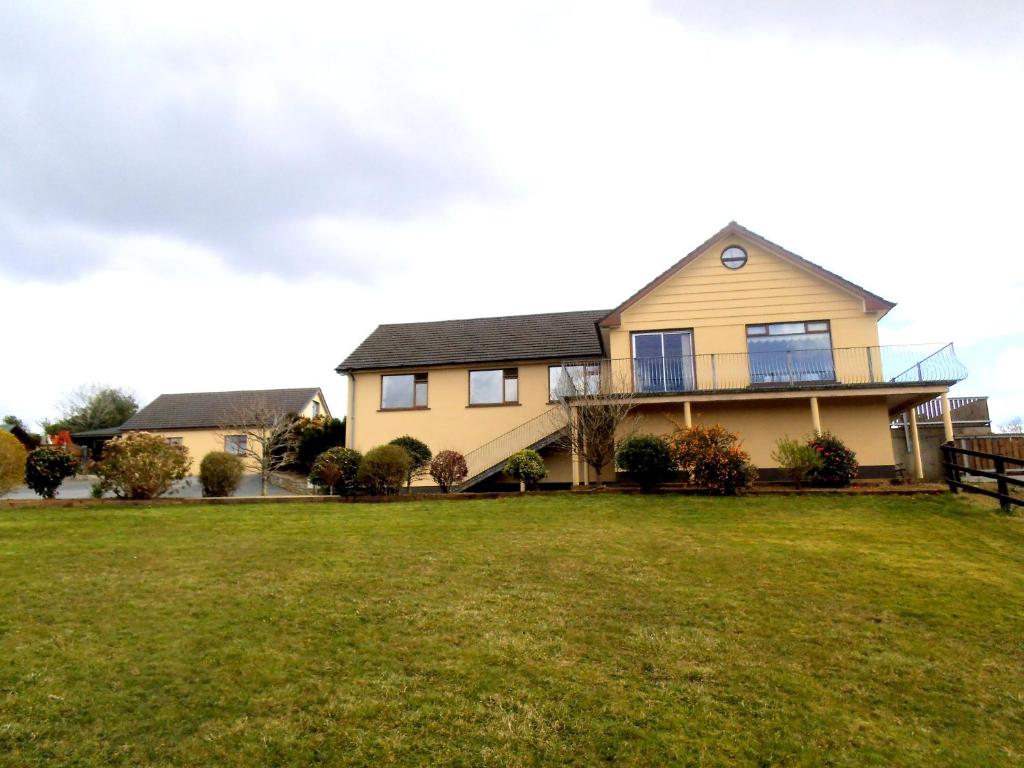 a large house with a large lawn in front of it at La Mirage B&B in Bantry