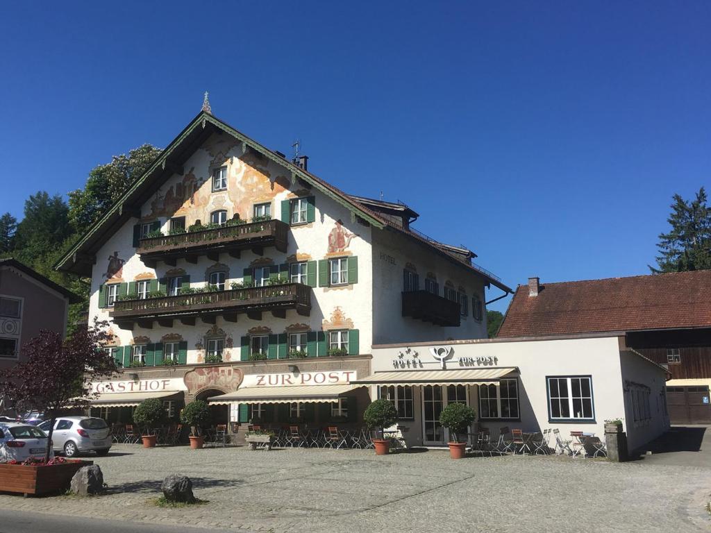 um grande edifício branco com muitas janelas em Hotel zur Post em Kochel