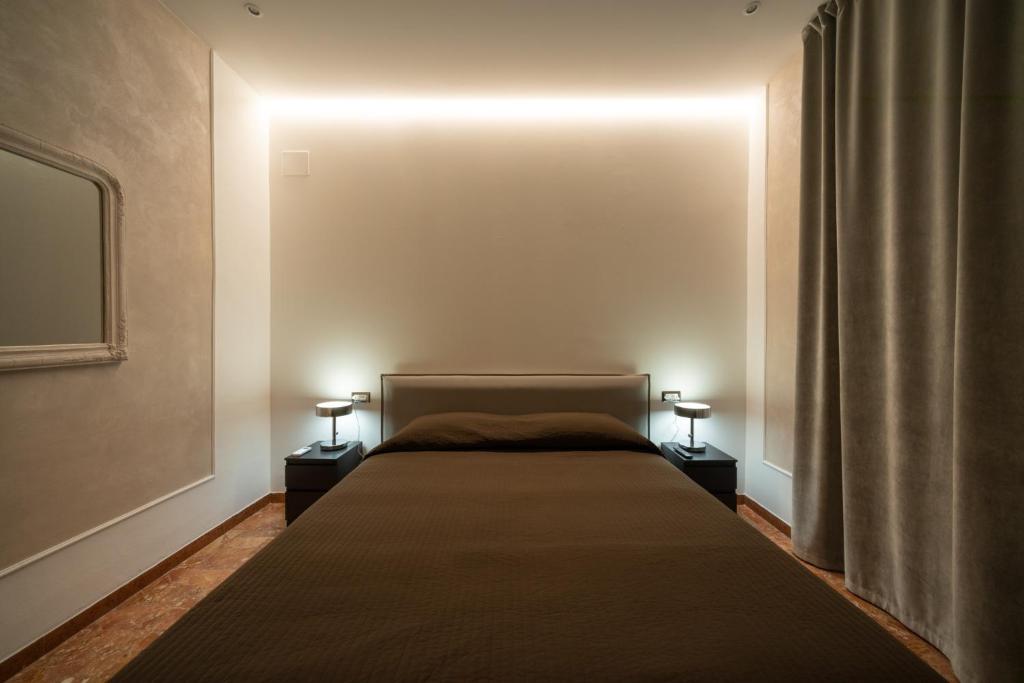 a bedroom with a large bed with two night stands at Residence Sferisterio in Macerata