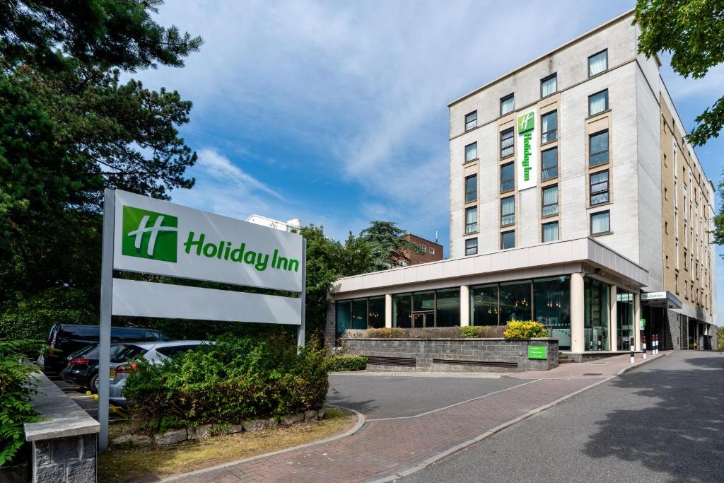 a large building with a sign on the side of it at Holiday Inn Bournemouth, an IHG Hotel in Bournemouth