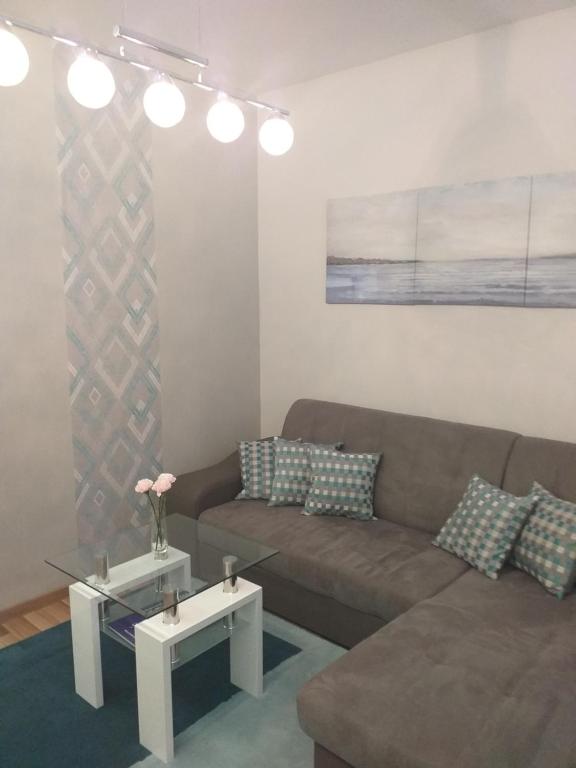 a living room with a couch and a table at Elizabeth Apartman 2 in Hévíz
