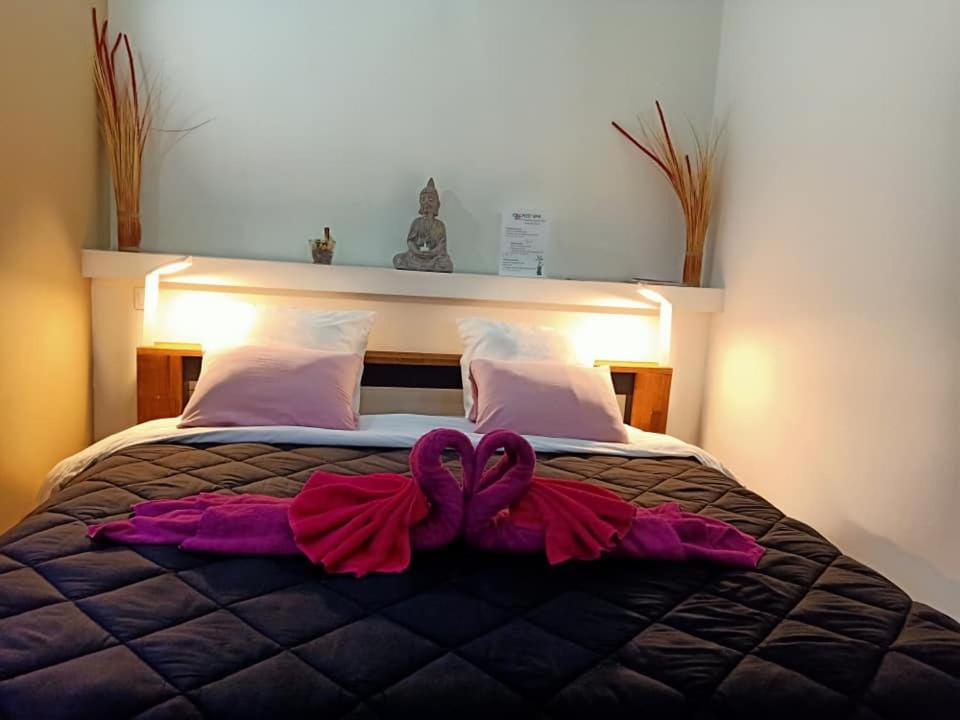 a bed with two bows on top of it at Mas La Farelle Chambre d&#39;hote,Fitness &amp; Salle de jeux Gratuite &amp; SPA en supplément in Nîmes