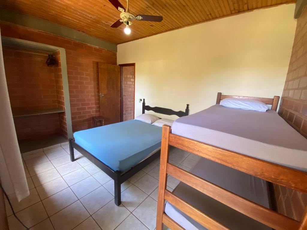 En eller flere senger på et rom på Residencial Varandas de Setiba