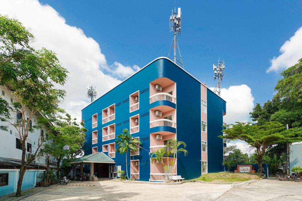 a blue building with balconies on the side of it at Mayfa Hotel - SHA extra plus in Phuket
