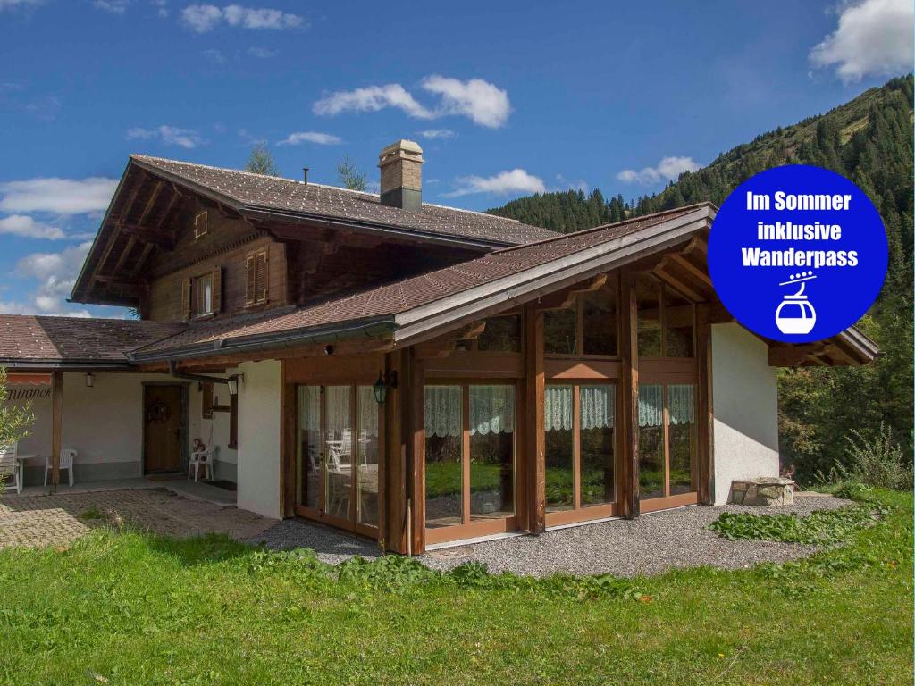 a house with a sign that reads the summer ministry willingnessyardsyards at Chalet Sturmfang in Adelboden