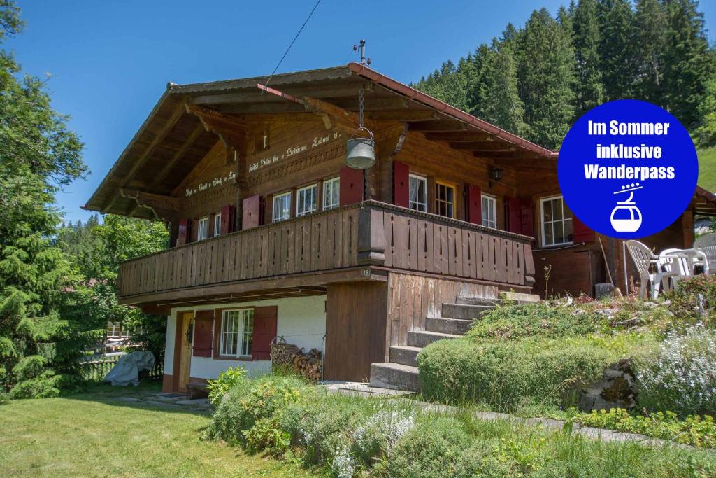 a house with a sign in front of it at Chalet Iris in Adelboden