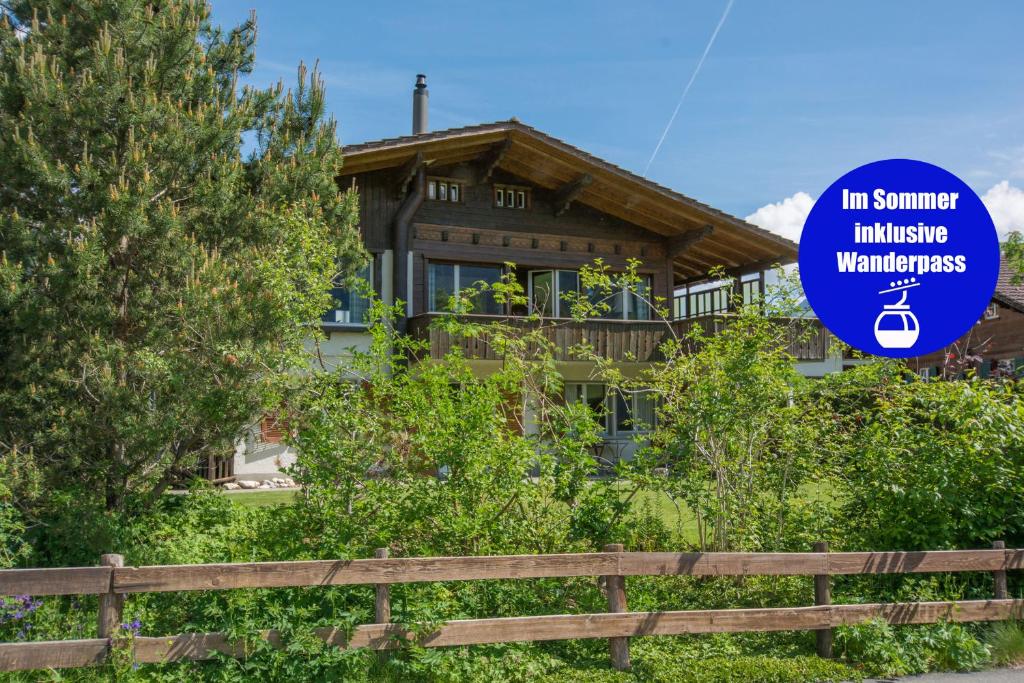 a house with a sign that reads in summer invisible warranties at Ferienwohnung Bim Stei in Adelboden