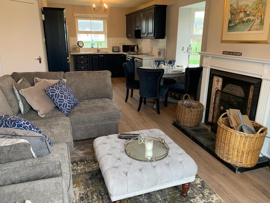 a living room with a couch and a fireplace at Rosslare Wexford in Saint Helens