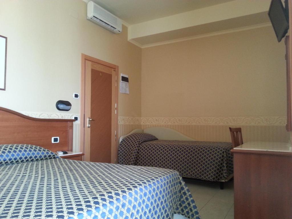 Postel nebo postele na pokoji v ubytování Hotel Grifone